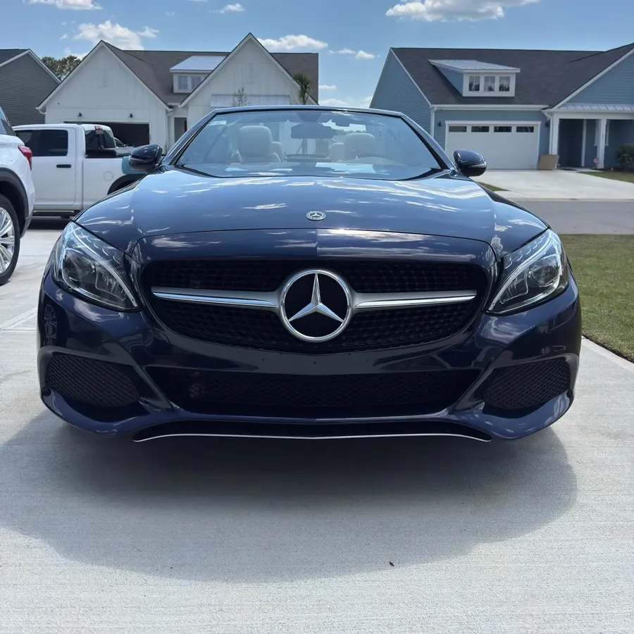 Navy Mercedes convertible in a driveway after a detail